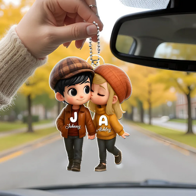 Keychain with cartoon characters on a car dashboard with autumn scenery